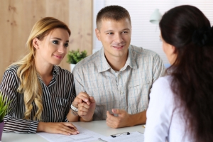 Young family couple trying to get loan at bank clerk office. Husband and wife asking social service officer for child adoption permission. Planning future, married life, expectation, mortgage concept